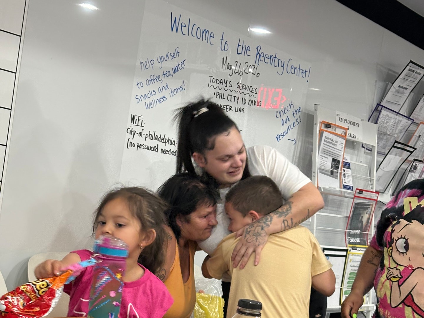 Participants connect at the F.U.S.E reentry center, with a welcome message on the whiteboard behind them.